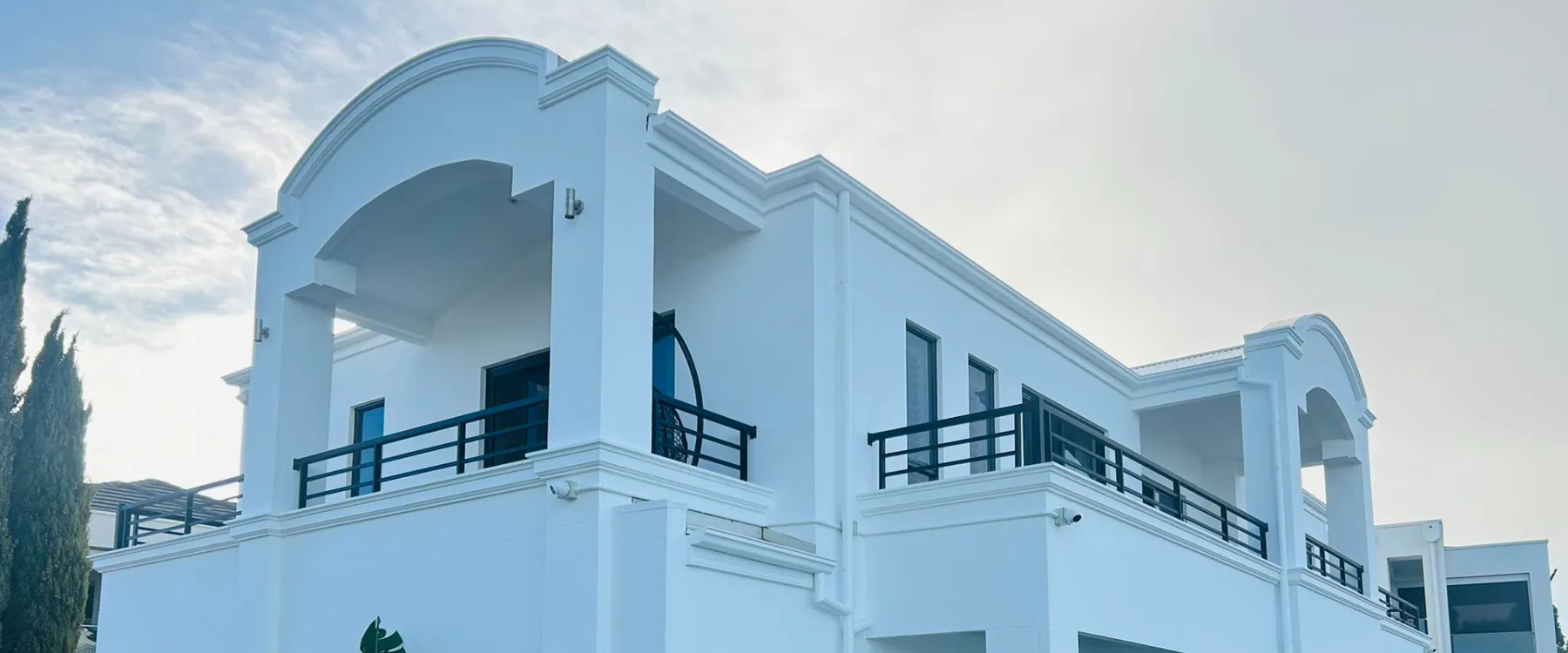 Art deco house exterior repainted white with curved corner detail
