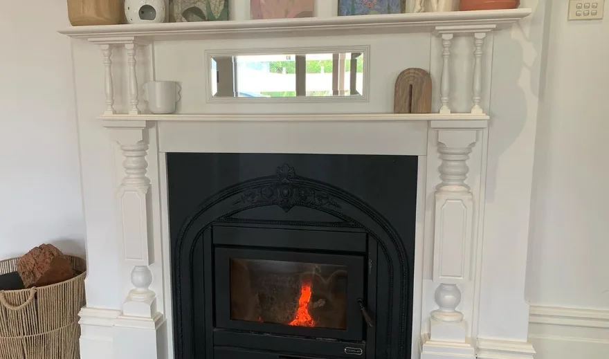 Living room fireplace and mantel painted white with matching walls
