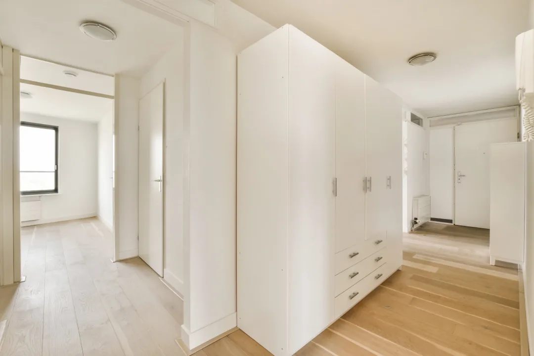 Built-in wardrobes and bedroom walls painted white